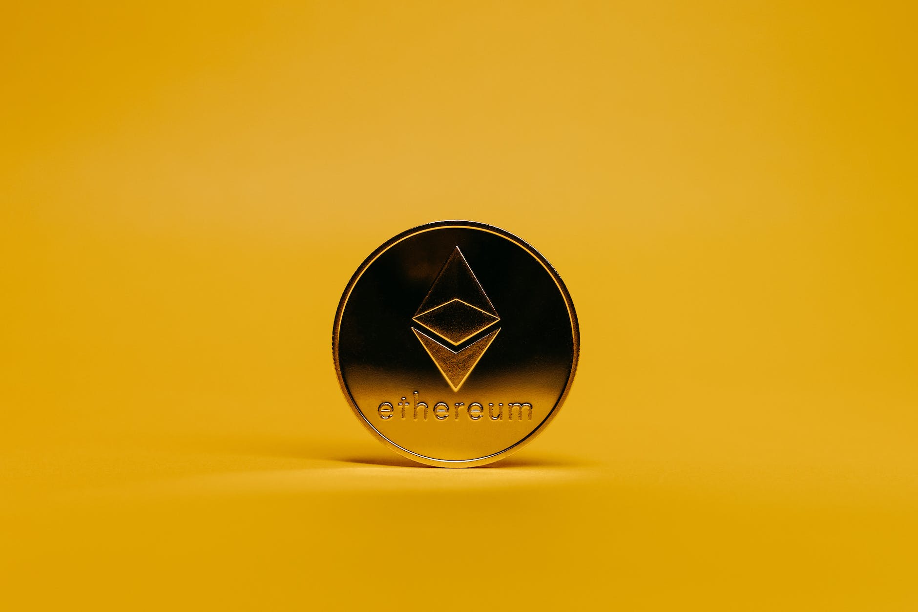 ethereum coin on yellow background