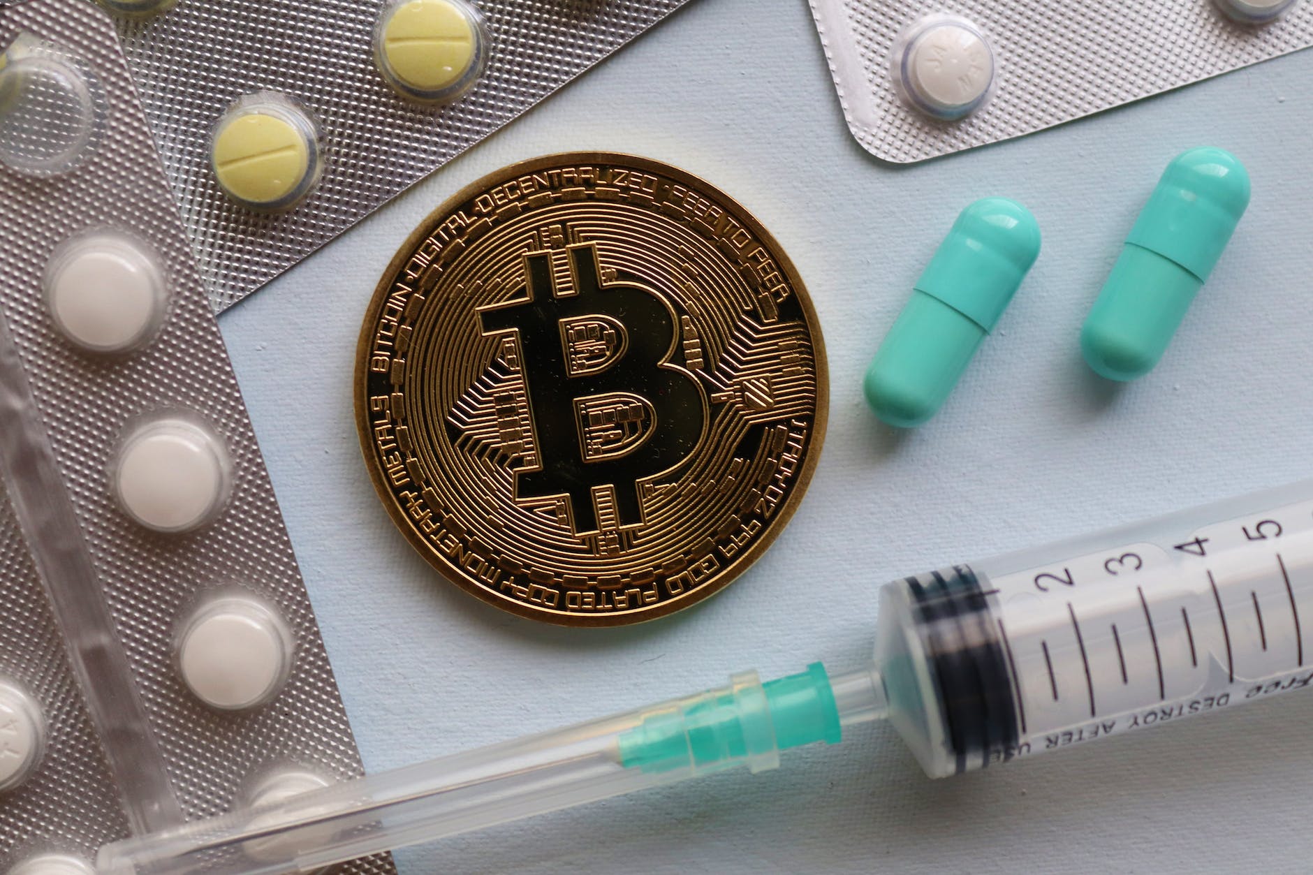 bitcoin and pills on table